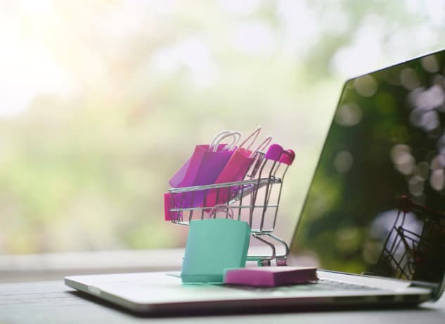 Shopping cart ontop of a laptop