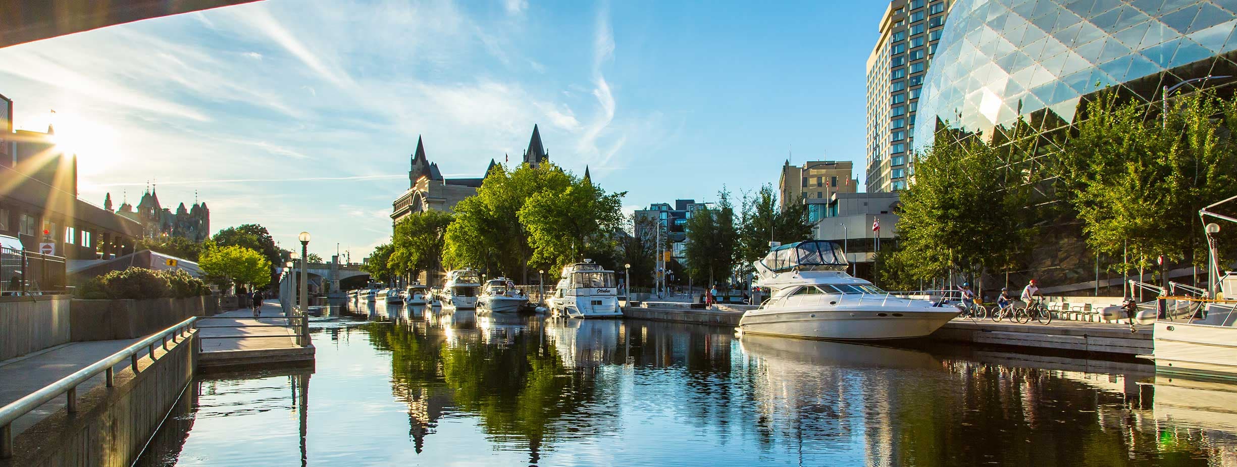 Sunset landscape of Ottawa with the view of the canal, Chateau Laurier, Parliament, NAC and conference center.