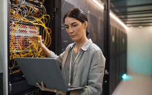 Systems administrator working inside of a datacenter.