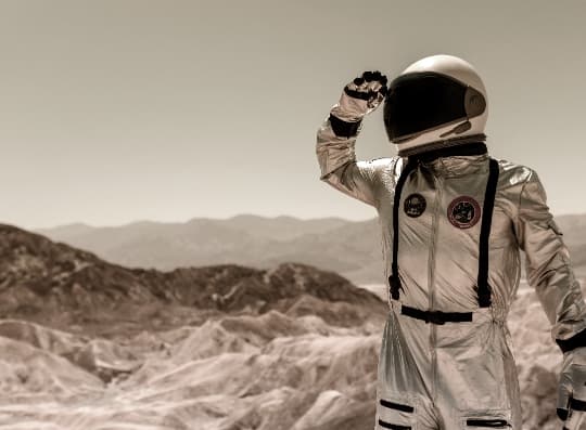 An astronaut taking a look at the horizon.